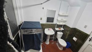 a small bathroom with a sink and a toilet at Zona Sur, Bajo Seguencoma Flat in La Paz +17 photos