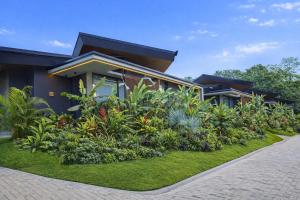 a house with a bunch of plants in front of it at Noah's Hideaway by Tifakara in Fortuna