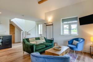 a living room with a green couch and two blue chairs at 2 Bed in Waldron oc-v33536 in Waldron