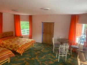 a bedroom with a bed and a table and chairs at Hotel Bellavista in Calca