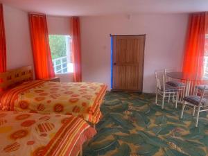 a bedroom with two beds and a table and chairs at Hotel Bellavista in Calca +27 photos