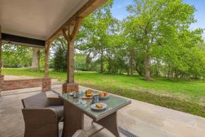 a patio with a table and chairs and trees at 2 Bed in Waldron oc-v33536 in Waldron