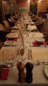 a long table with plates and wine glasses on it at Bakucha Vineyard Hotel ve Spa in Lüleburgaz