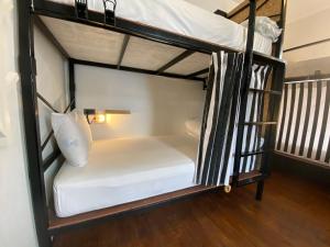 a couple of bunk beds in a room at Sherloft Home & Hostel in Chiang Mai