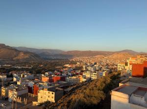 a view of a city with mountains in the background at SeArt Home by the Ocean in Aourir