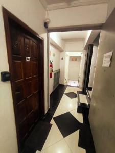 a hallway with a door and a tile floor at Studio premium -- ap 06 in Diadema +16 photos