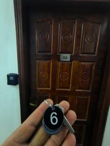 a person holding a key in front of a door at Studio premium -- ap 06 in Diadema