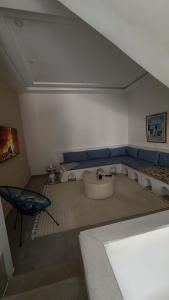 a room with a sink and a couch and a table at Sidi bou duplex in La Goulette