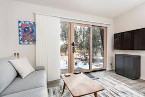 a living room with a couch and a table at The Pinyon - Mountain View Retreat in Carbondale