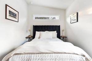 a bedroom with a large bed with two night stands at The Pinyon - Mountain View Retreat in Carbondale