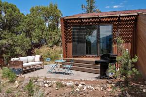 a tiny house with a couch and a stove at The Pinyon - Mountain View Retreat in Carbondale