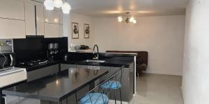 a kitchen with a sink and a stove top oven at Room cerca al aeropuerto #2 in Bogotá
