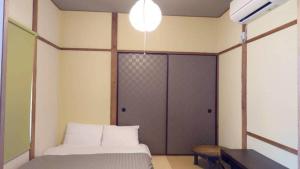 a bedroom with a bed and a sliding door at Hakone No Yado in Hakone
