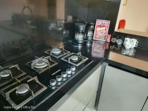 a stove top oven sitting on a kitchen counter at Room cerca al aeropuerto #4 in Bogotá