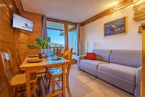 a living room with a couch and a table at Mountain View with Ski-In and Out Loft - Résidence Roche Blanche in Val Thorens +35 photos