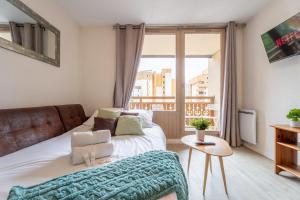 a bedroom with a bed and a window at Mountain View with Ski-In and Out Loft - Résidence Roche Blanche in Val Thorens