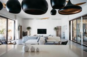a living room with a large couch and a table at 5BR Exclusive Beachfront Villa with Pool in Tulum in Balcheil