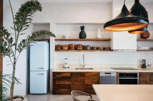 a kitchen with a refrigerator and a sink at 5BR Exclusive Beachfront Villa with Pool in Tulum in Balcheil