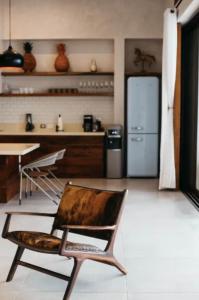 a chair in a kitchen with a refrigerator at 5BR Exclusive Beachfront Villa with Pool in Tulum in Balcheil +18 photos