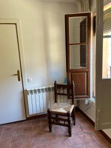a chair sitting in a room with a radiator at La Casonna - Aluenda in El Frasno