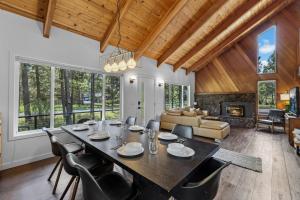 a dining room with a table and chairs and a living room at Three Rivers Basecamp - Meredith Lodging in Sunriver