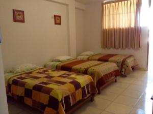 a bedroom with two beds in a room at Hostal La Estancia in Ica +10 photos