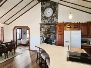 a kitchen and living room with a stone fireplace at Peaceful Pasture Farm in Fort Edward