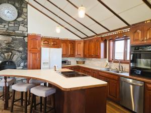 a kitchen with wooden cabinets and a stone wall at Peaceful Pasture Farm in Fort Edward +44 photos