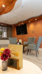 a conference room with a table and chairs and a tv at The Watling Inn in Nuneaton