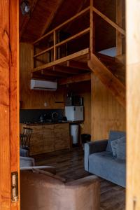 a living room with a bunk bed and a couch at Cabañas Origen Bosque y Río in Melipeuco