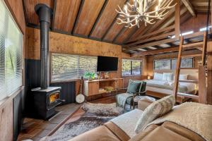 a living room with a bed and a fireplace at Cascade Springs in North Tumbulgum