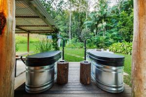 two large metal tanks sitting on a wooden deck at Cascade Springs in North Tumbulgum