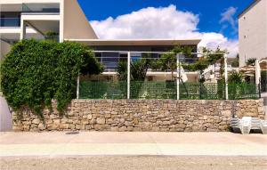 a stone retaining wall in front of a house at Holiday Home Grljevacka Vi in Podstrana