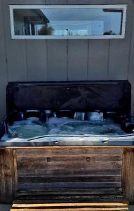 a bed in a room with a black mattressvisor at Ginrosa B and B accommodation in Featherston