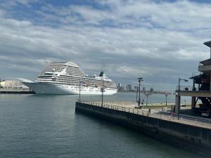 a cruise ship in the water next to a dock at Private Inn Bambee in Kobe