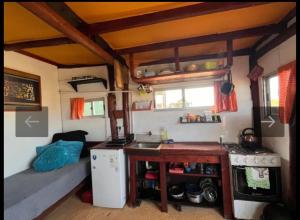 a kitchen with a sink and a stove in a room at Casa Sur in Cabo Polonio