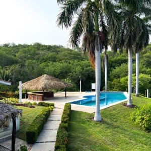 a resort with a swimming pool and palm trees at Casa Palma in Santa Cruz Huatulco