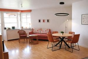 a living room with a couch and a table at Ferienwohnung -West Häfele Blick in Hagnau
