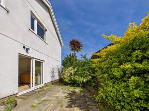 a house with a pathway next to a building at Luxury Seaview Escape - Mumbles in Oystermouth