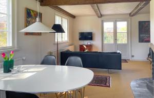 a living room with a white table and chairs at Nice Home In Ry With Wifi in Ry