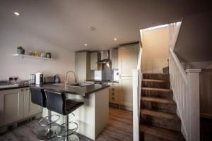 a kitchen with a sink and a counter with a staircase at Ard Dhub House Your 3 Bedroom cottage retreat in Waternish in Hallin
