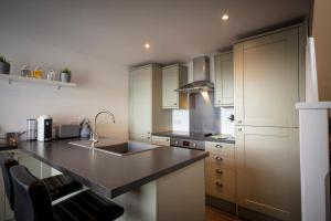 a kitchen with a sink and a counter top at Ard Dhub House Your 3 Bedroom cottage retreat in Waternish in Hallin +24 photos