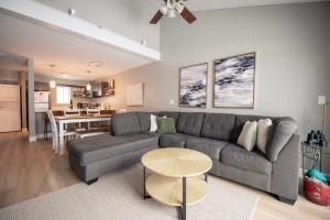 a living room with a couch and a table at Newly Renovated Condo in Harborside! in South Haven