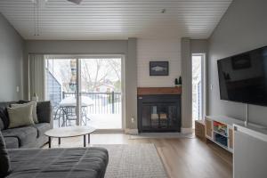 a living room with a couch and a fireplace at Newly Renovated Condo in Harborside! in South Haven