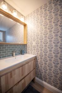 a bathroom with a sink and a mirror at Newly Renovated Condo in Harborside! in South Haven +12 photos