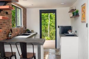 a kitchen with a sink and a counter with chairs at Margaritas House in Buenos Aires