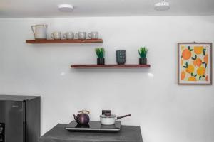 a kitchen with a stove with pots and pans on it at Margaritas House in Buenos Aires +14 photos