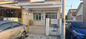 two cars parked in front of a house at Twenty2 Homestay Sepang in Sepang