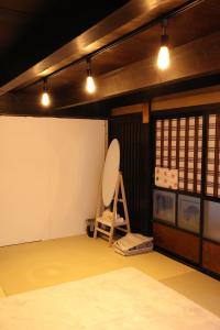 a room with a mirror and a chair in it at 古民家宿そらいえ in Asago