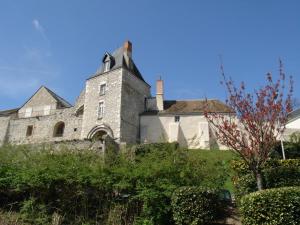 an old stone building with a tower on a hill at Hôtel Le Forestia in Pannes